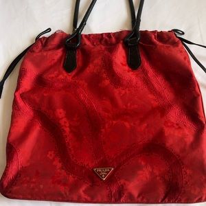 Prada red patterned handbag with leather handles